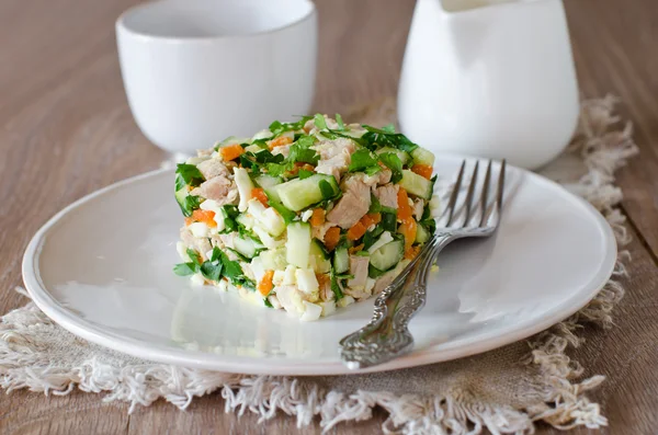 Salad with chicken, carrots, eggs and cucumbers — Stock Photo, Image