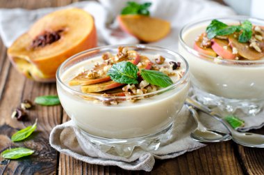Peach mousse with nuts and mint clipart