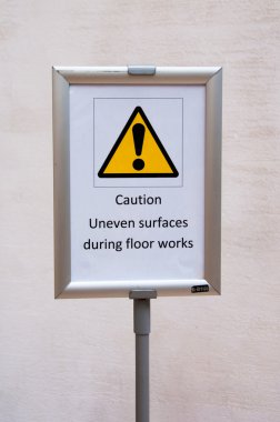 Caution Uneven surfaces during floor works clipart