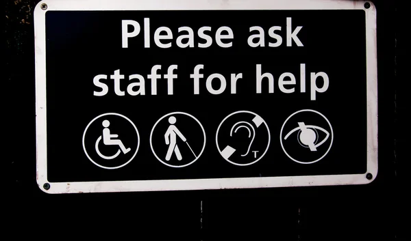 Warning Sign for handicapped please ask staff for help — Stock Photo, Image