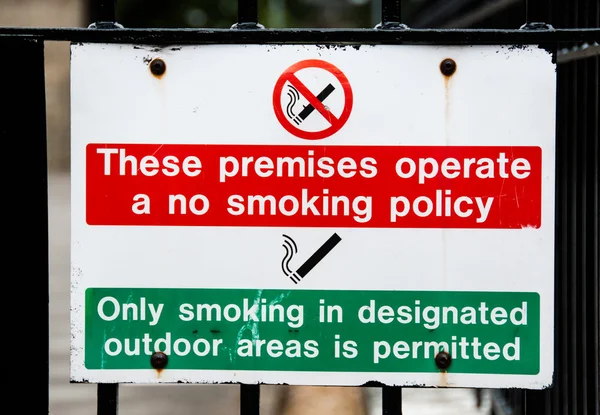 No smoking on premises sign, only smoke in designated areas — Stock Photo, Image