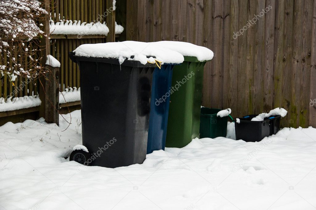 Snow covered recycling bins