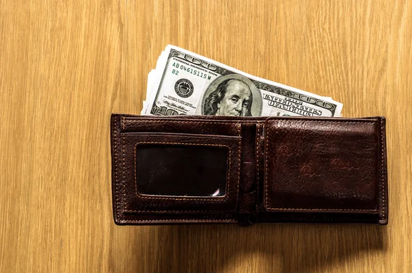 Wallet with money on wooden background — Stock Photo, Image