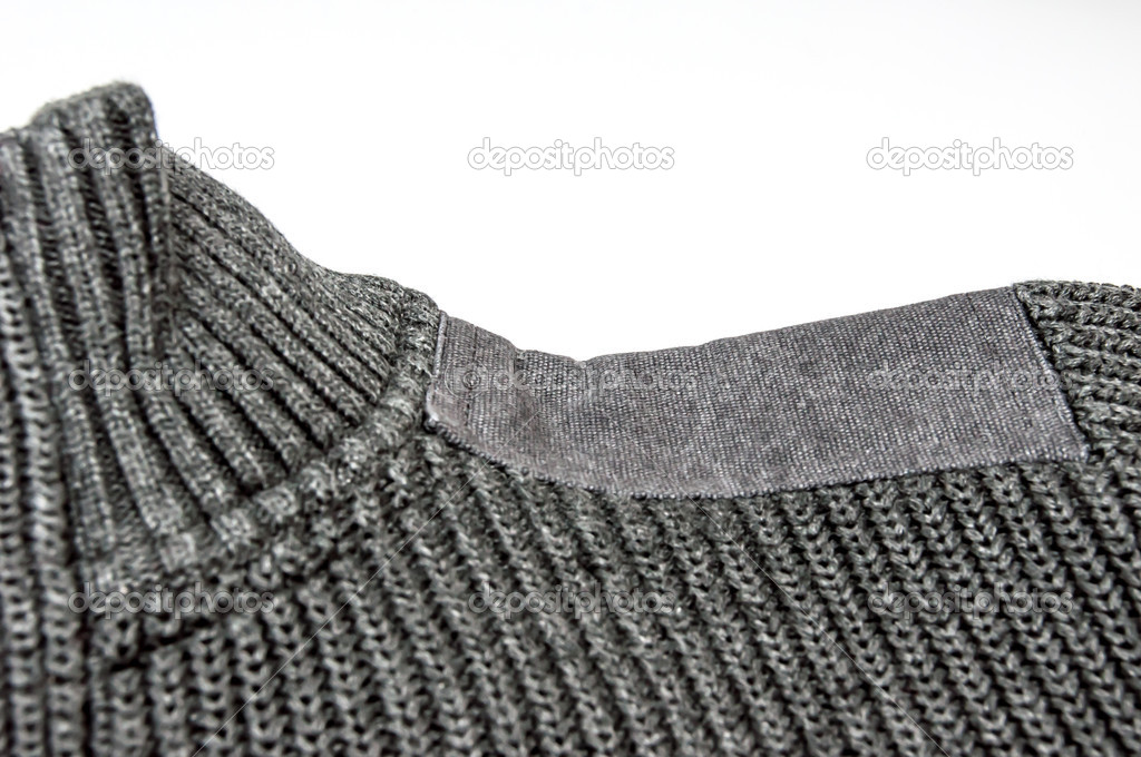 Close up of gray sweater with shoulder pad