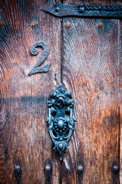 Number 2 on a vintage door with door knocker for use as a background — Stock Photo, Image