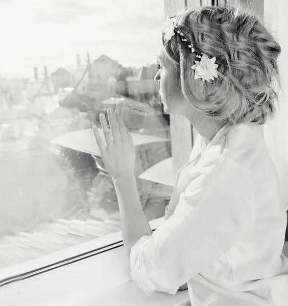 Kvinna som tittar genom fönstret — Stockfoto