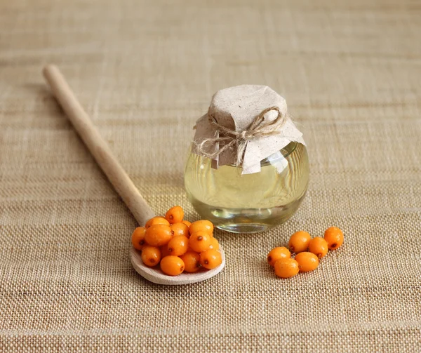 Sea buckthorn oil in glass jar — Stock Photo, Image