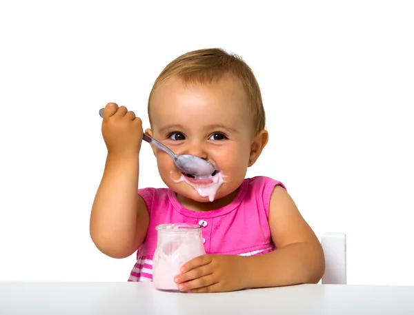 Girl eating yogurt — Stock Photo, Image