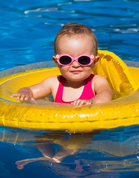 Baby swimming in a pool Royalty Free Stock Images