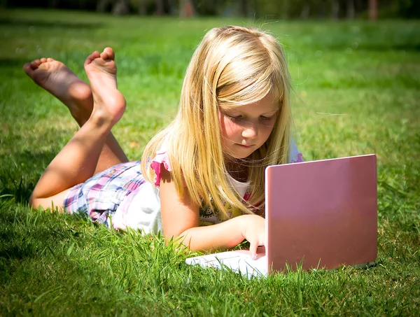 Little girl with laptop — Stock Photo, Image