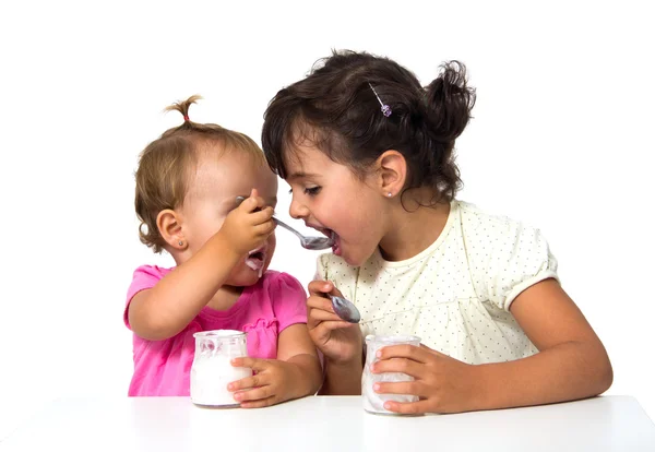 Små flickor att äta yoghurt — Stockfoto