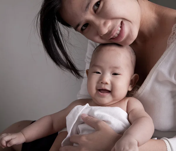 Studio shot of loving mother holding baby — Stock Photo, Image