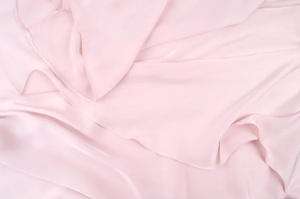 Světle růžový hedvábný přehoz, pozadí nebo texturu. růžový hedvábný materiál — Stock fotografie