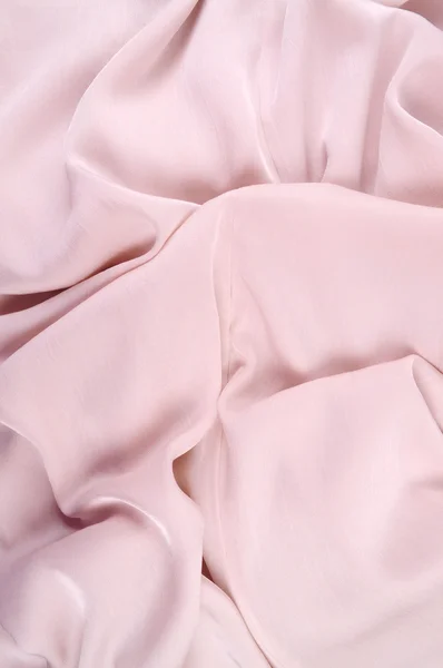 Светло-розовая шелковая драпировка, фон или текстура. Розовый шелк — стоковое фото