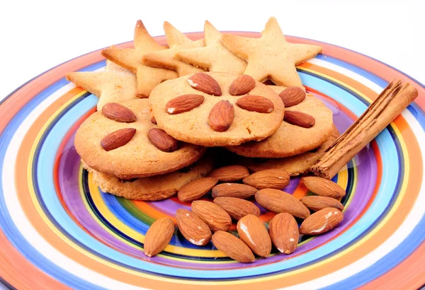 Christmas cookies. Homemade biscuits on colourful dish, isolated on white background. — Stock Photo, Image