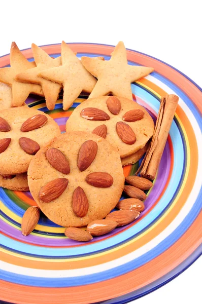 Christmas cookies. Homemade biscuits on colourful dish, isolated on white background. — Stock Photo, Image