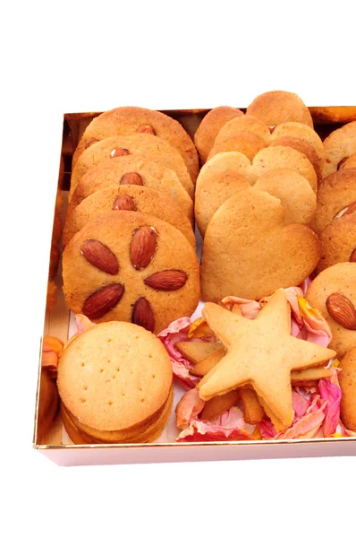 Christmas baking. Assorted biscuits in a gold box, isolated on white background — Stock Photo, Image