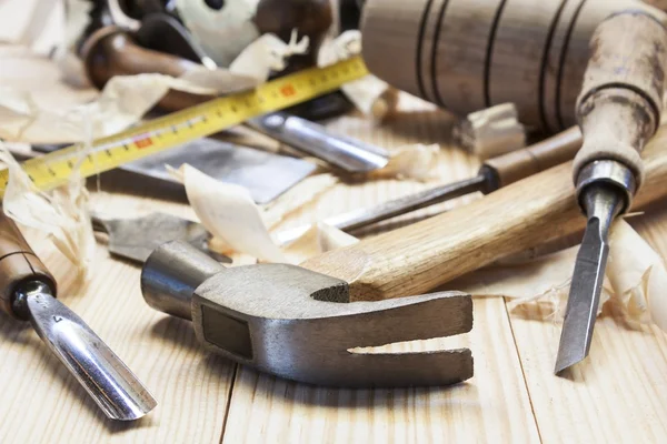 Carpenter tools in pine wood table — Stock Photo, Image