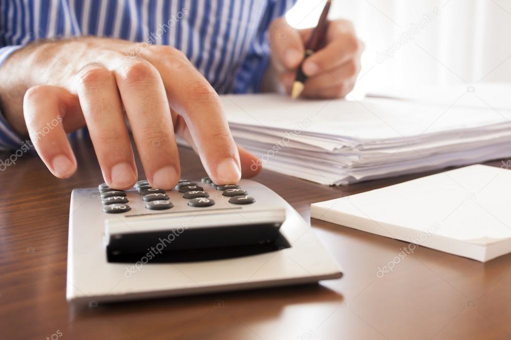Business men working with documents and calculator in the office