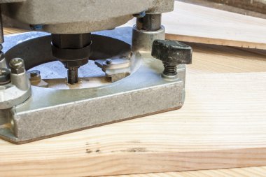 Electronic Plunge Router with pine wood planks,construction background