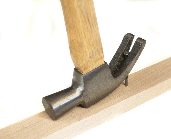 Carpenter work with hammer and nail isolated on white — Stock Photo, Image