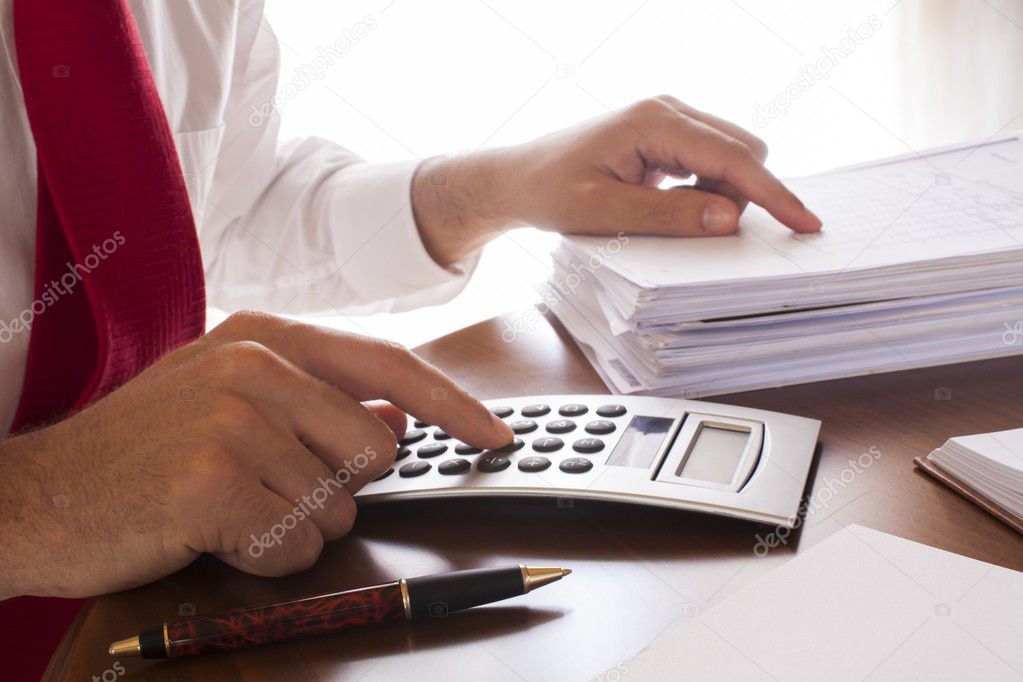 Business men working with documents and calculator in the office