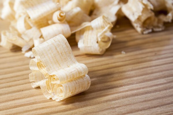Wooden shaving on pine wood background,woodwork carpentry