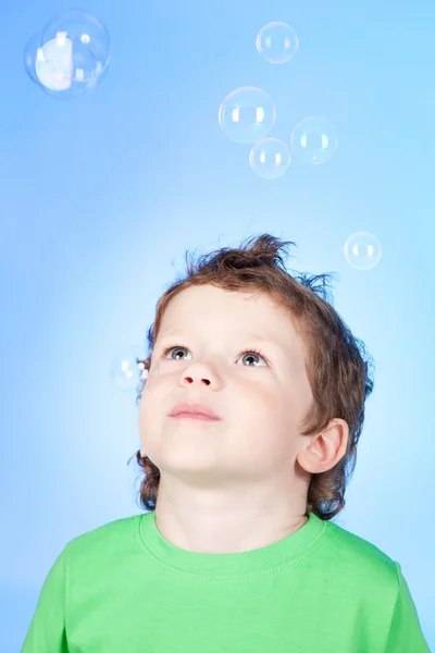 Portrait de drôle de petit garçon soufflant des bulles de savon — Photo