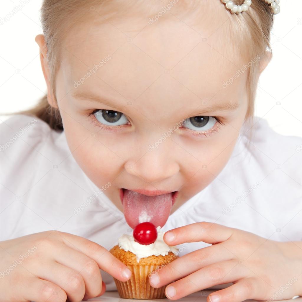 Closeup portrait of sweet little girl with cake