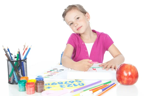 Little brunette girl drawing at the desk — Stock Photo, Image