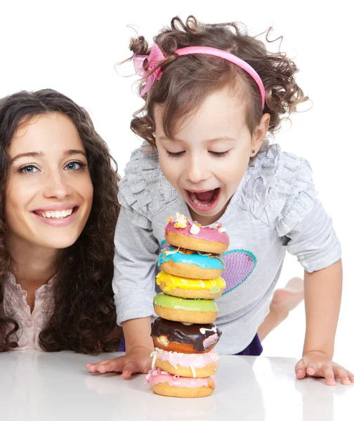 Picture of happy mother and little girl with colorful donuts — Stock Photo, Image