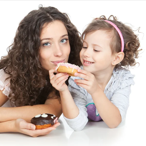 Picture of happy mother and little girl with colorful donuts — Stock Photo, Image