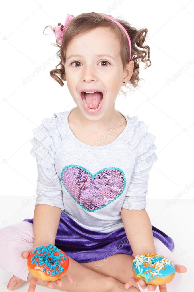 Portrait of emotionally little girl with donuts over white