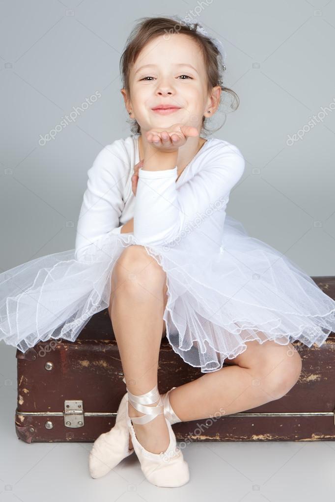 Beautiful little dancer, ballerina in white dress