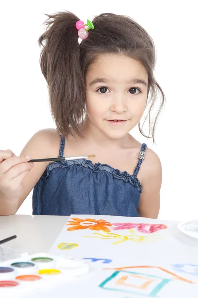 Little brunette girl drawing at the desk — Stock Photo, Image