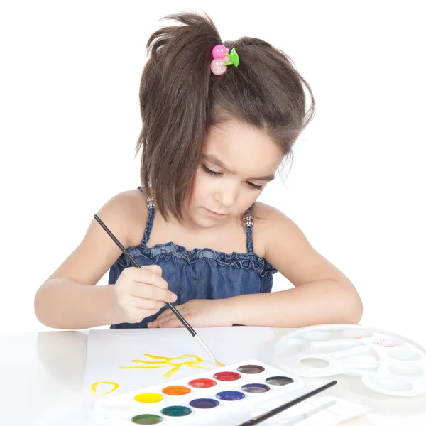 Little brunette girl drawing at the desk — Stock Photo, Image