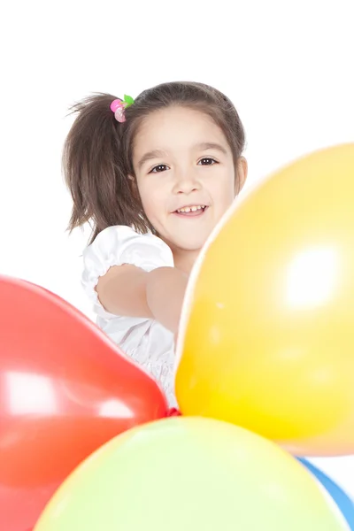 Little brunette girl with balloons in studio Royalty Free Stock Photos