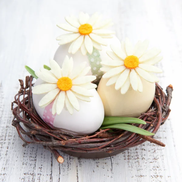 Easter eggs and flowers in a nest — Stock Photo, Image