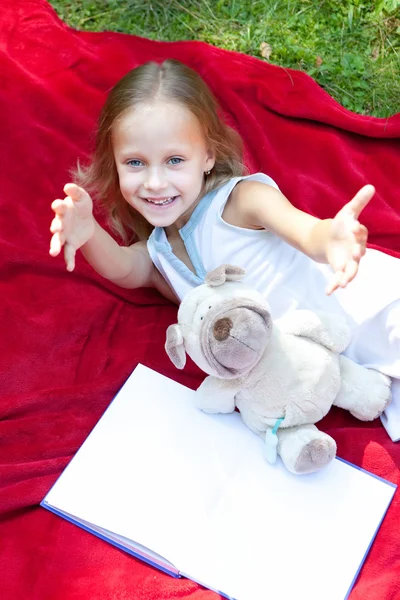 Funny little girl in a park — Stock Photo, Image