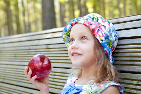 Little girl with red apple — Stock Photo, Image