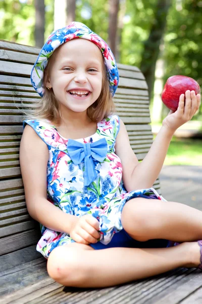 Little girl with red apple — Stock Photo, Image