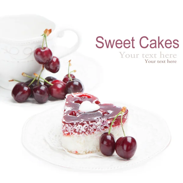 Sweet cakes with cherries on white — Stock Photo, Image