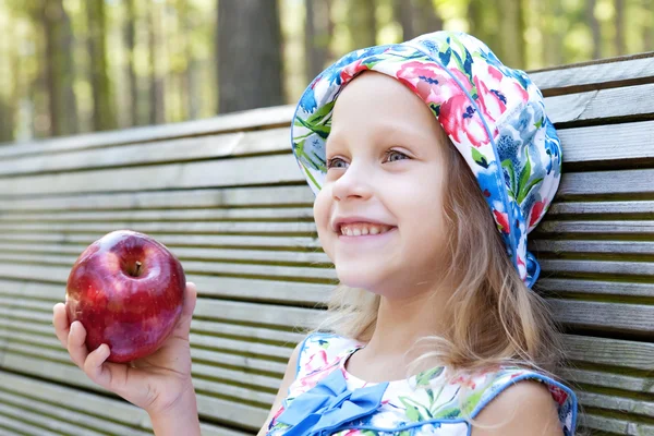 Little girl with red apple — Stock Photo, Image