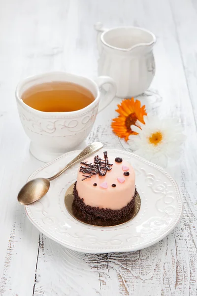 Sweet cake on a white wooden table — Stock Photo, Image