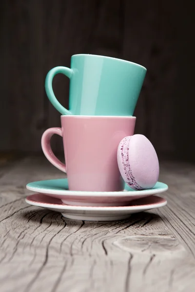 Tazas de café con macarrones franceses sobre mesa de madera — Foto de Stock