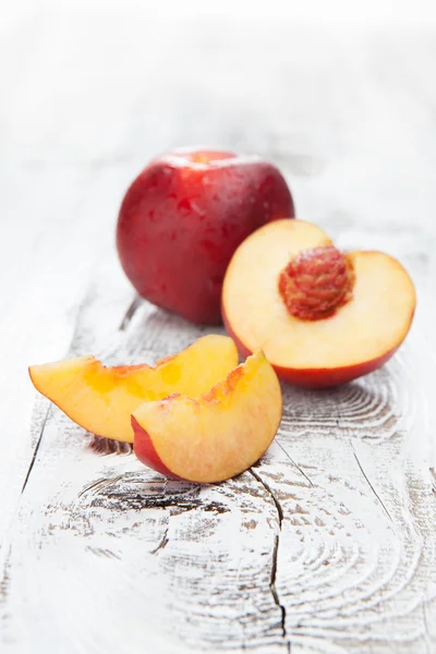 Vers en smakelijk perziken op een tafel — Stockfoto