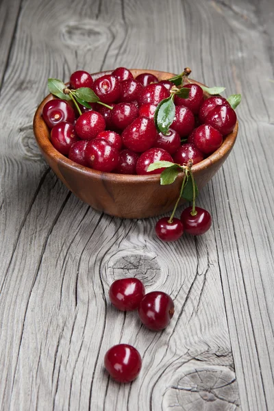 Fresh and tasty cherries on woden table — Stock Photo, Image