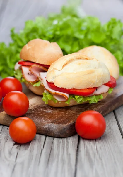 Sandwiches on a wooden background — Stock Photo, Image