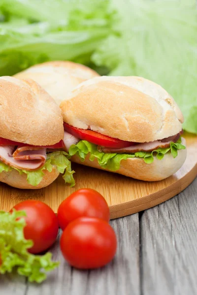 Sandwiches on a wooden background — Stock Photo, Image