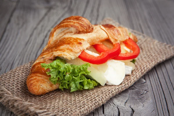 Fresh croissant with cheese on a table — Stock Photo, Image